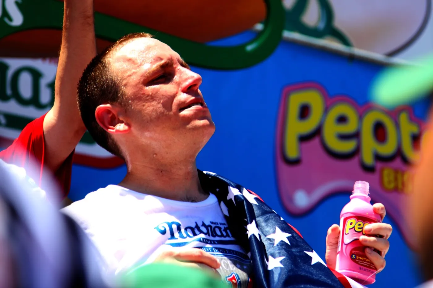 Joey Chestnut draped in the American flag after winning the 2010 Nathan's Hot Dog Eating Contest